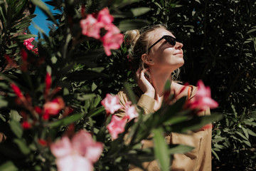 Naklejka premium Young girl on nature among flowering trees.