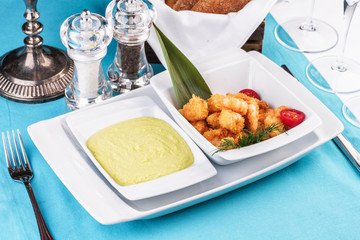 European cuisine, Mediterranean dish. Shrimps, cleaned without shell, fried in batter, beer snack with creamy mustard sauce