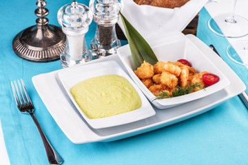 European cuisine, Mediterranean dish. Shrimps, cleaned without shell, fried in batter, beer snack with creamy mustard sauce