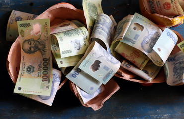 save up Vietnamese dong banknote, saving money from broken piggy bank