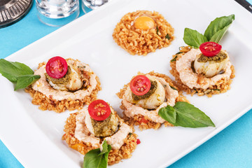 European cuisine, Mediterranean dish. Rice in soy sauce with poached egg, with tomato, cream sauce and basil, according to an Italian recipe