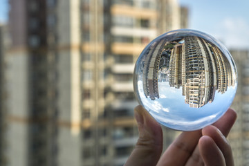round Glass ball with big city buildings background