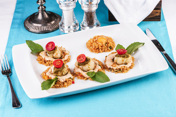 European cuisine, Mediterranean dish. Rice in soy sauce with poached egg, with tomato, cream sauce and basil, according to an Italian recipe