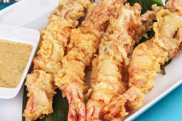 European cuisine, Mediterranean dish. Whole prawns fried in butter and batter snack for beer with cream-mustard sauce