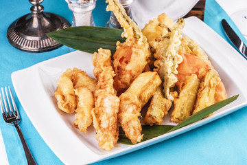 European cuisine, Mediterranean dish. Whole crab legs, crab meat fried in batter on butter, beer snack with creamy mustard sauce