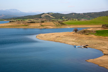 old rowing boat, cool blue still water