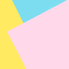 Background of blue, pink, yellow papers. Geometric, minimal background in pastel colors