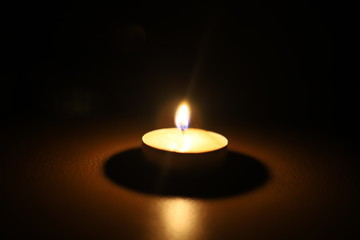 burning candle tablet in the dark