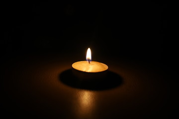 burning candle tablet in the dark