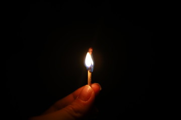 fire burning match in hands