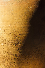 A fragment of an old clay pot. The surface of the ceramic product. Texture. Close-up. The small depth of field