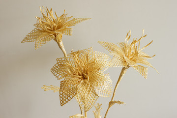 Bouquet of flowers made of straw on a light background