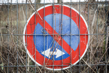 german no parking traffic sign, behind a metal fence