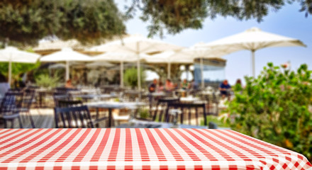 Table background  in a restaurant outdoor view. Empty  space for your decoration and an advertising product.