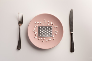 Blister with pills on the plate. Flat lay.