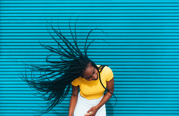 African american woman waving her dreadlocks