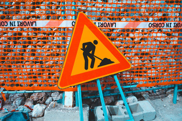 building site sign with some stones in the background