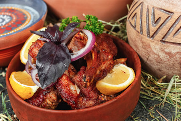 Georgian chicken stew with vegetables, greens, lemon and onions in Georgian. National cuisine