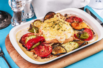 Mediterranean dish, Georgian recipe. Baked chicken steak with lemon, vegetables, pepper, zucchini, eggplants and grilled tomatoes with spices