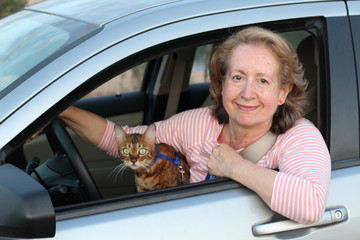Cute mature female driver with her cat
