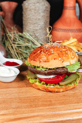 Hamburger with french fries, ketchup and creamy sauce in oriental style in Georgian. National cuisine