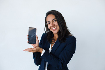 Happy businesswoman showing smartphone. Beautiful young woman holding cell phone with blank screen...