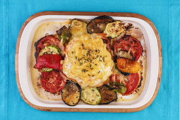 Mediterranean dish, Georgian recipe. Baked chicken steak with lemon, vegetables, pepper, zucchini, eggplants and grilled tomatoes with spices