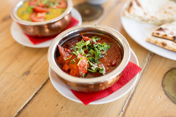 food, south asian cuisine, culinary and cooking concept - close up of kidney bean masala in bowl on table of indian restaurant