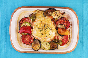 Mediterranean dish, Georgian recipe. Baked chicken steak with lemon, vegetables, pepper, zucchini, eggplants and grilled tomatoes with spices