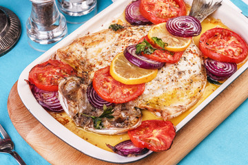 Seafood, Mediterranean cuisine, European dish. Baked entirely in foil fish with onion rings, pimodori, zucchini and baclazans under fragrant spices. Caucasian national cuisine