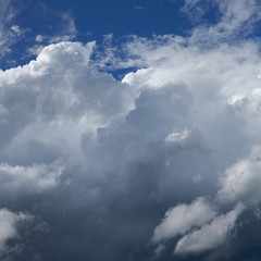 White and dark clouds against a blue sky.
