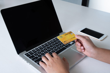 woman use credit card for online shopping on her laptop and phone