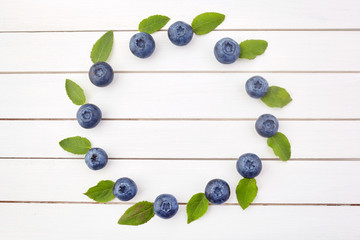 Naklejka na ściany i meble Framework made of blueberry on white wooden background. Flat lay. Food concept.