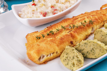 Fried fish steak carp served with greens, chili pepper, boiled rice, rosemary, thyme and mashed potatoes with dill according to the Georgian recipe. Mediterranean Kitchen