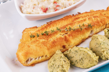 Fried fish steak carp served with greens, chili pepper, boiled rice, rosemary, thyme and mashed potatoes with dill according to the Georgian recipe. Mediterranean Kitchen