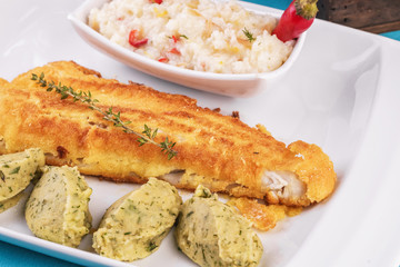 Fried fish steak carp served with greens, chili pepper, boiled rice, rosemary, thyme and mashed potatoes with dill according to the Georgian recipe. Mediterranean Kitchen