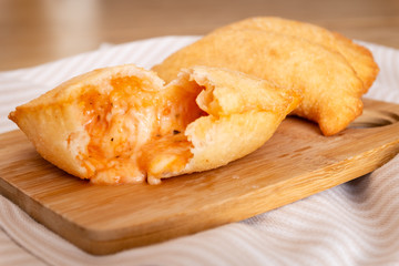 Close up of fried panzerotto stuffing made of mozzarella cheese and tomato. Typical Apulian food. Italy
