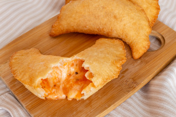 Close up of fried panzerotto hot stuffing. Traditional food of Puglia. Italy