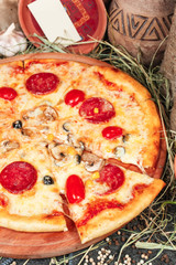 National pizza with salami, tomatoes, mushrooms, mozzarella cheese and Georgian corn. National cuisine