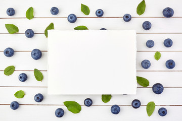 Framework made of blueberry on white wooden background. Flat lay. Food concept.