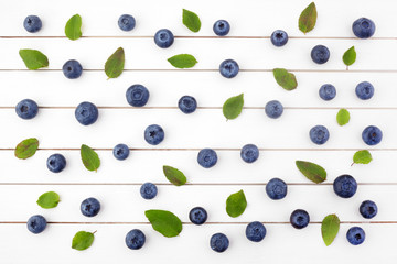 Creative layout made of blueberry on white wooden background. Flat lay. Food concept.