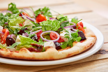 vegetarian pizza with fresh tomatoes, olives, tofu and red onion