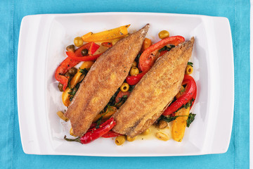  Grilled fish steak carp served with stewed chili peppers, olives, olives, greens and green pepper according to the Georgian recipe. Mediterranean Kitchen