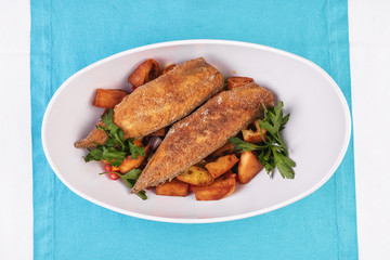  Grilled fish steak carp served with stewed chili peppers, olives, olives, greens and green pepper according to the Georgian recipe. Mediterranean Kitchen