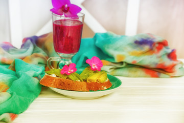 Sandwiches with coarse bread and avocado and  natural smoothies made from kiwi and greens. Healthy...