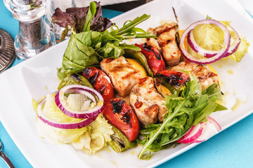  Seafood, Mediterranean cuisine, European dish. salad of assorted fish pieces grilled, with grilled vegetables - with onion rings, red and green pepper, chili pepper, greens, cheese, mushrooms 