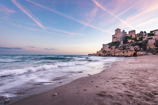 View of Tamarit beach and Castle at sunset, in Tarragona, Spain