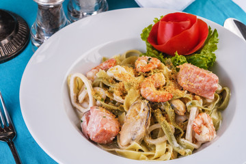  Mediterranean dish, Georgian recipe. Creamy pasta with shrimps, crab meat, seafood, squid rings, tomatoes, basil, greens and cheese.
