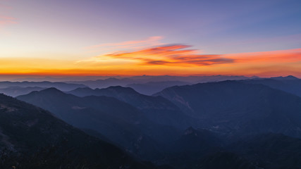 Golden and blue sky of a sunrise over mountains