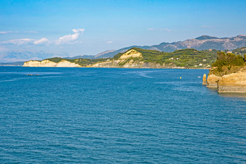 Fototapeta premium Aerial view of green rocky cliffs in the ocean.